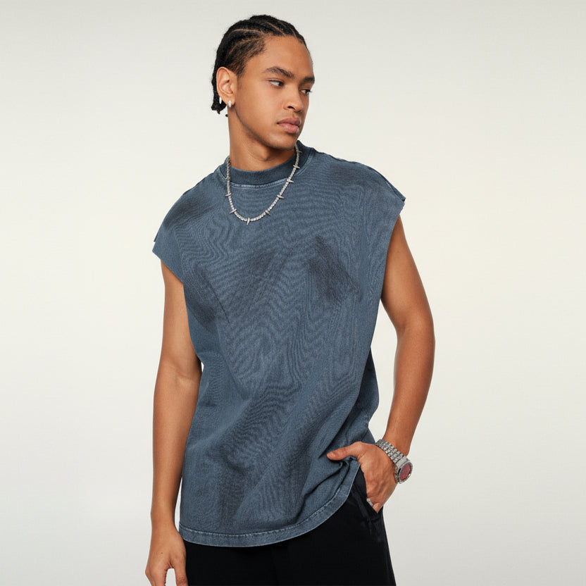 Person wearing a blue sleeveless shirt against a plain background