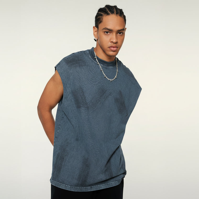 Man wearing a blue sleeveless denim top on a white background