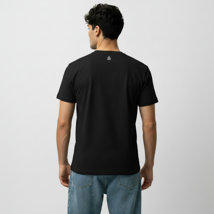 Man wearing a black t-shirt with a logo on the back against a light gray background