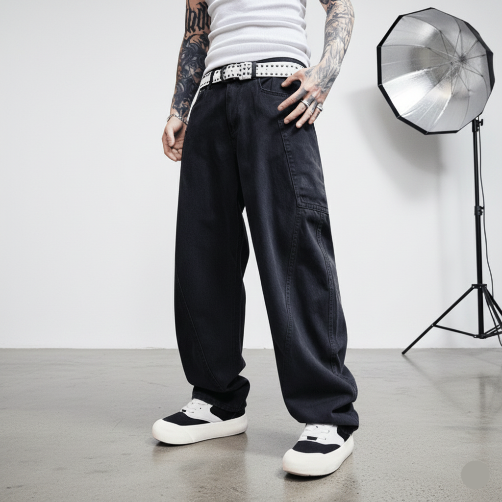 Person wearing black baggy pants with a white background and photography equipment.